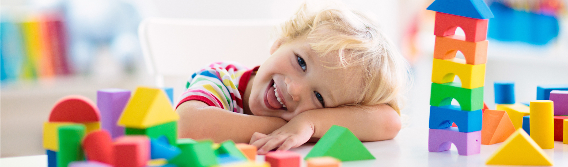 Kids toys. Child building tower of toy blocks.